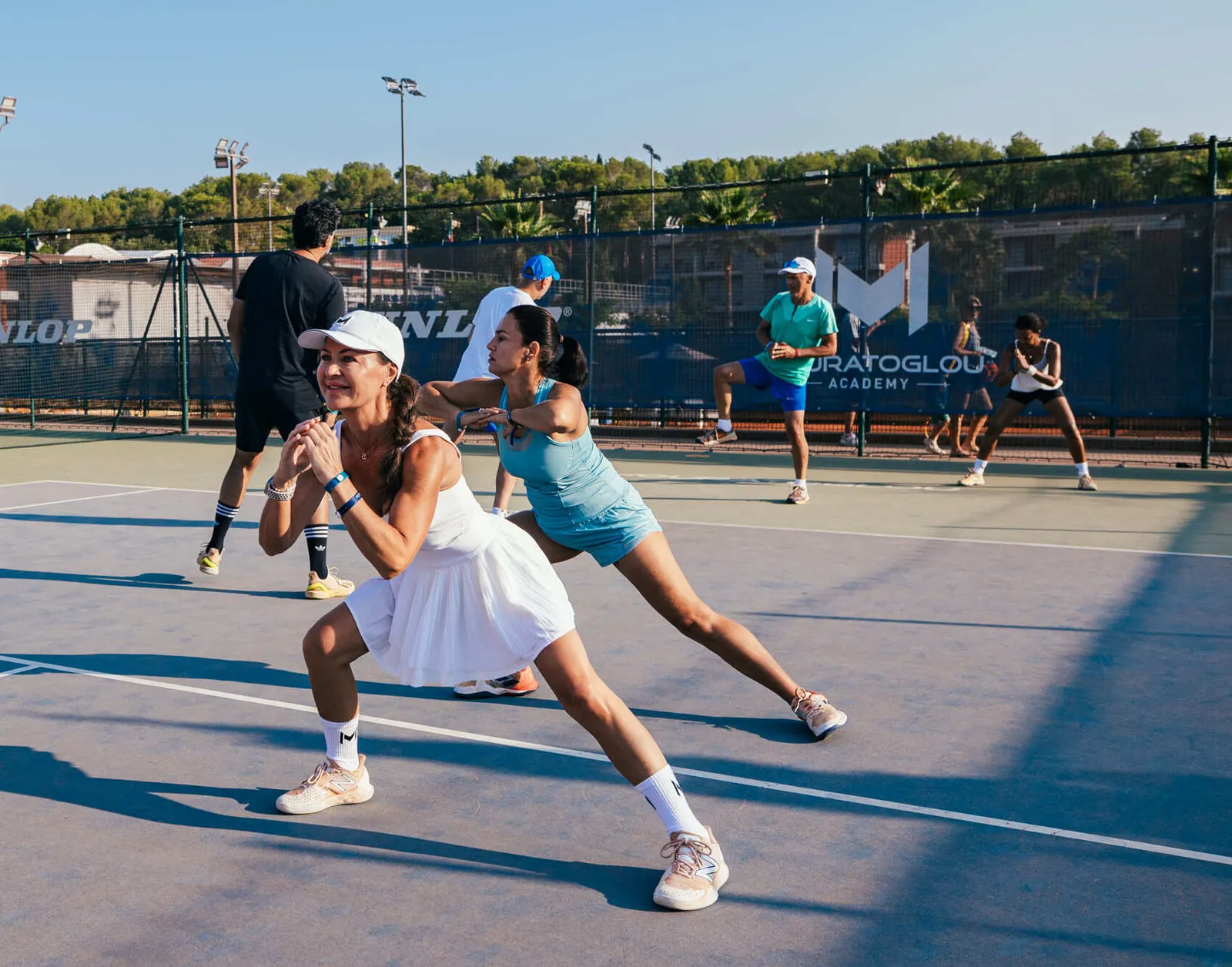 Player stretching with the help of a fitness coach