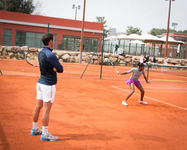 Player moving along the baseline to hit a forehand