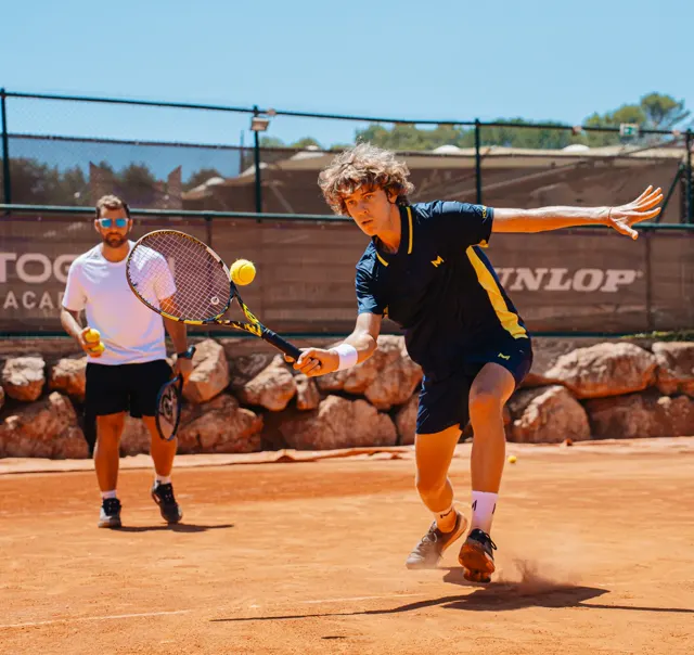Coach and players during a tennis lesson at the Mouratoglou Academy