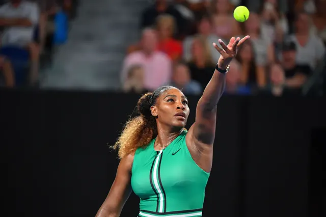 Player tossing the ball above the head on the serve