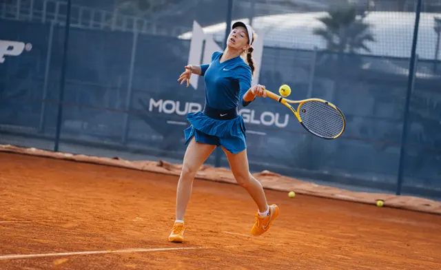Players practising on court with a basket of balls