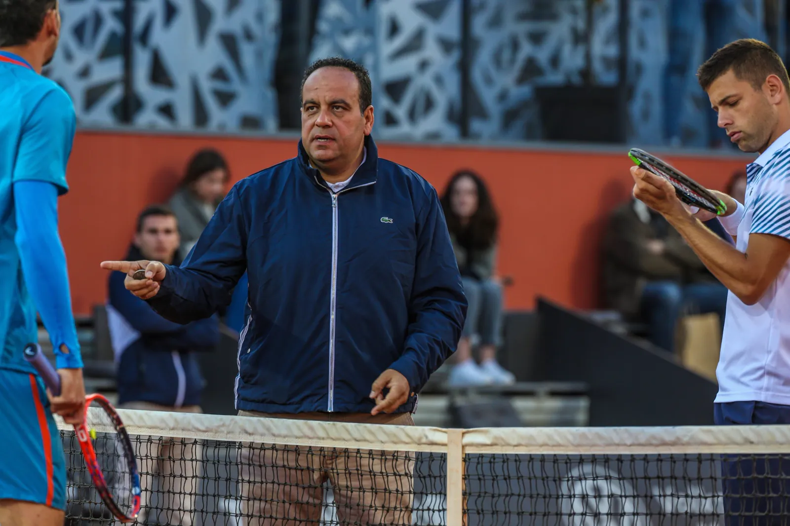 Oficial hablando con los jugadores cerca de la red durante un partido