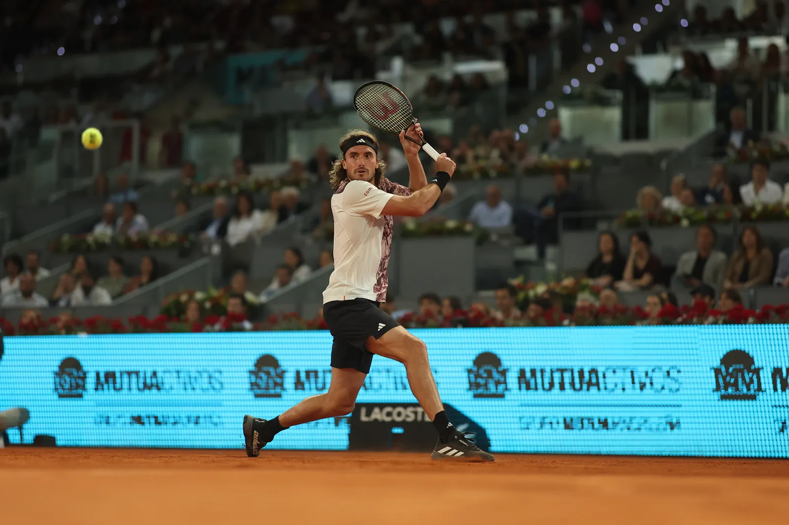 Player hitting a one-handed backhand side-on
