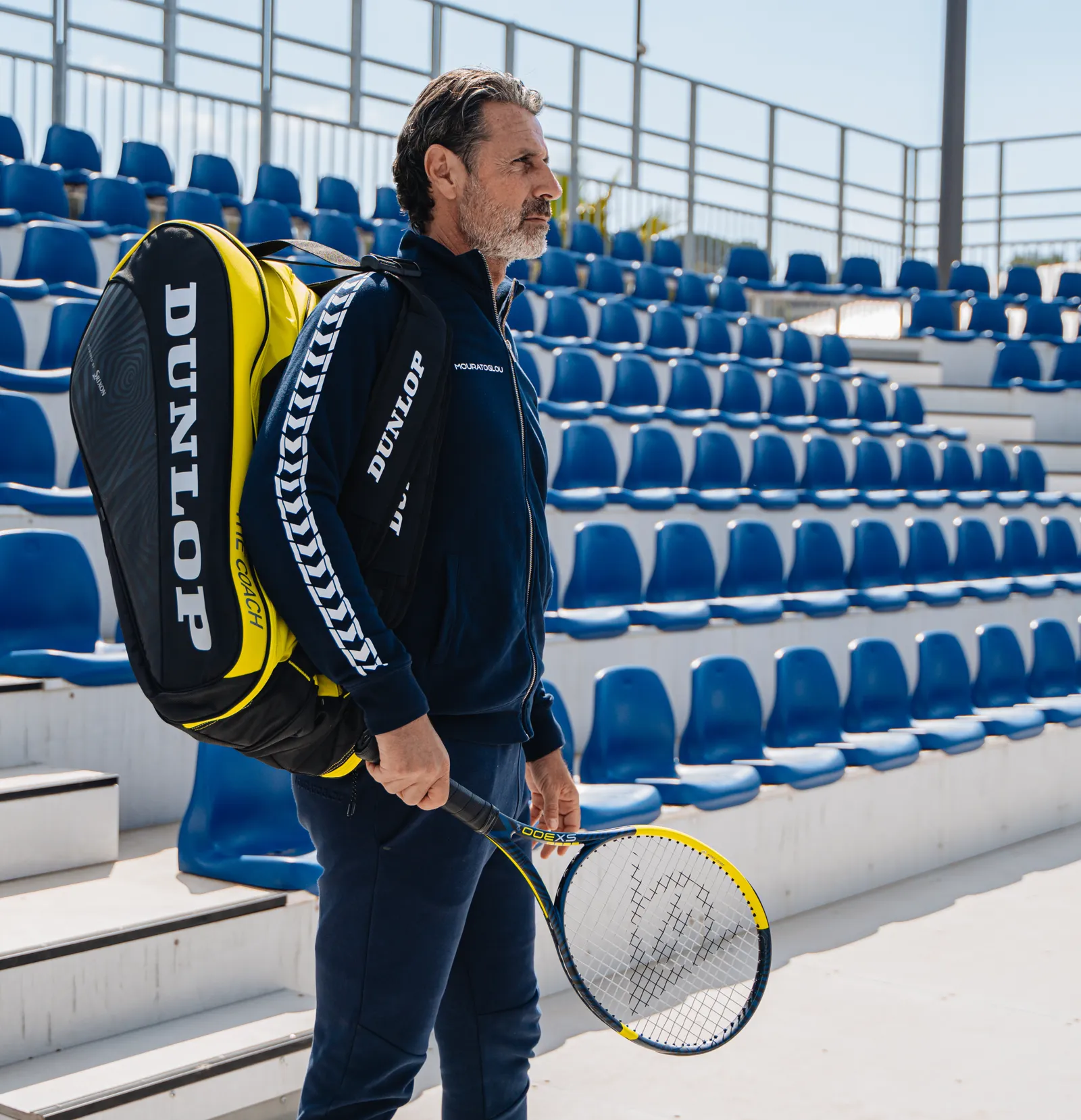 Patrick Mouratoglou on an Academy court, racquet in hand