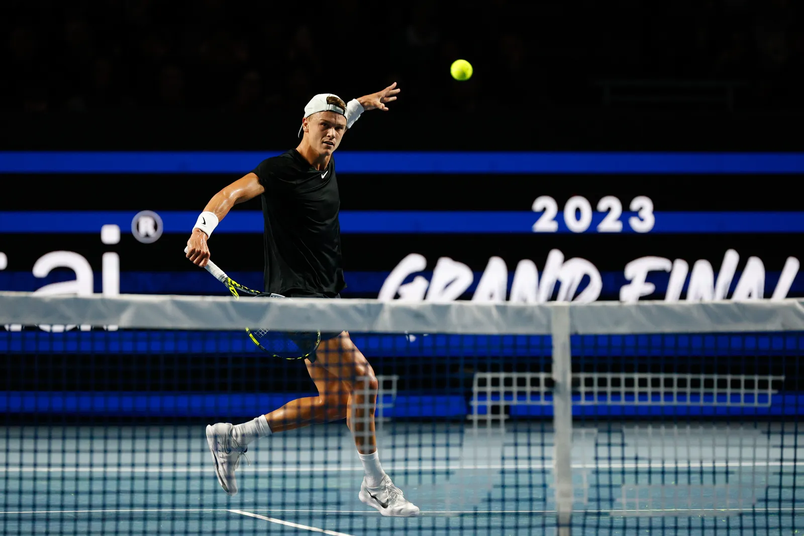 Holger Rune playing a drop shot during a match