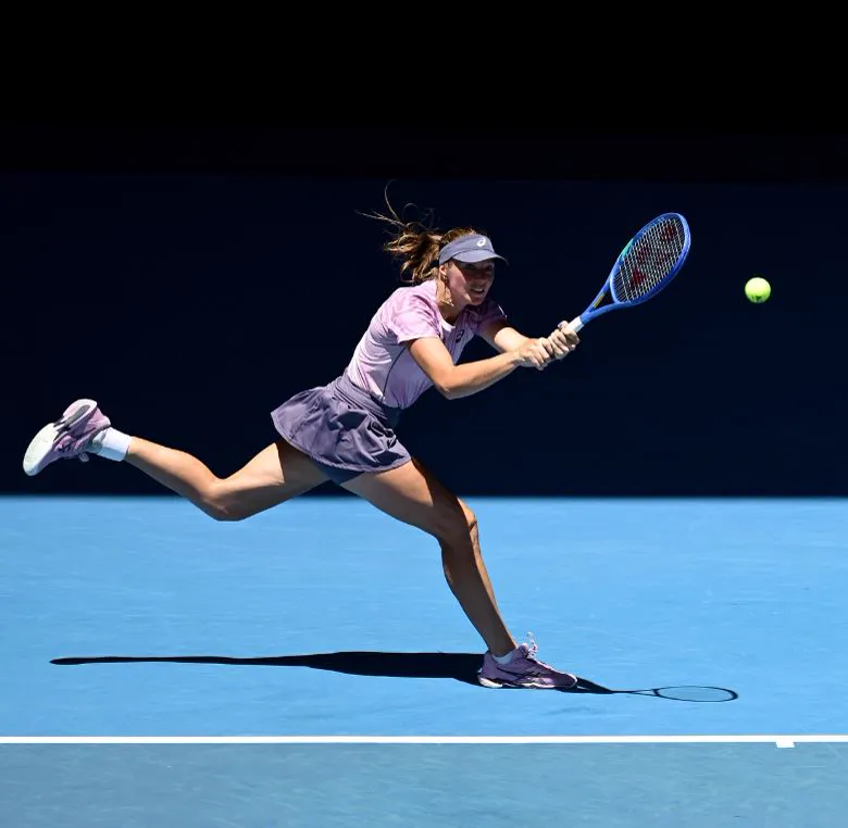 Player hitting a forehand on a blue hard court