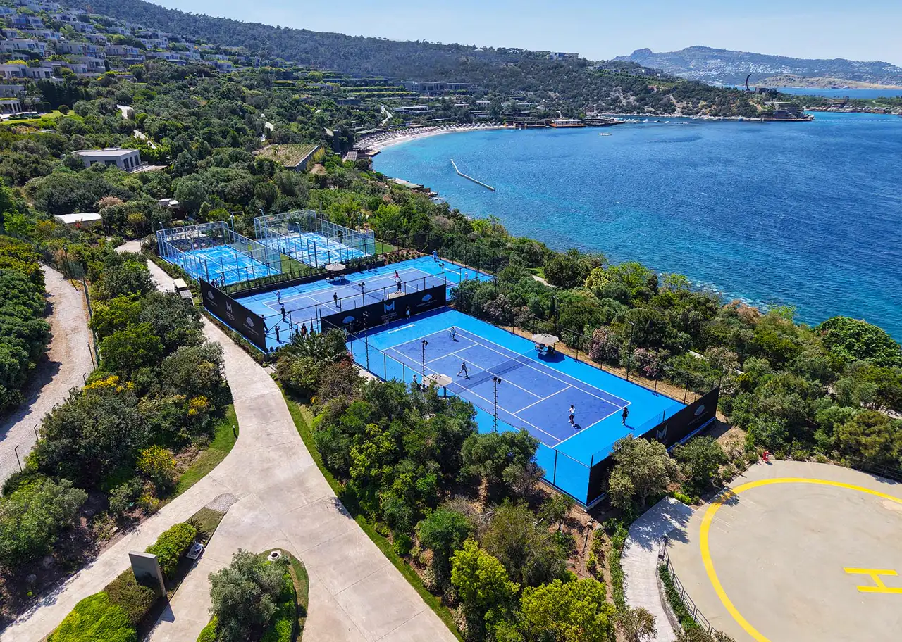 Aerial view of the panoramic padel courts of M Padel Bodrum above the sea