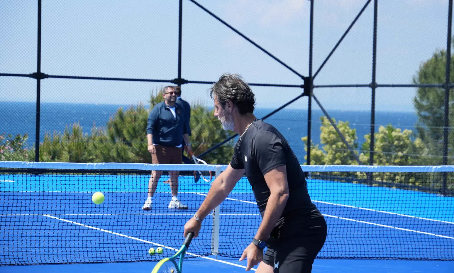 Patrick Mouratoglou playing padel on a court overlooking the sea in Bodrum