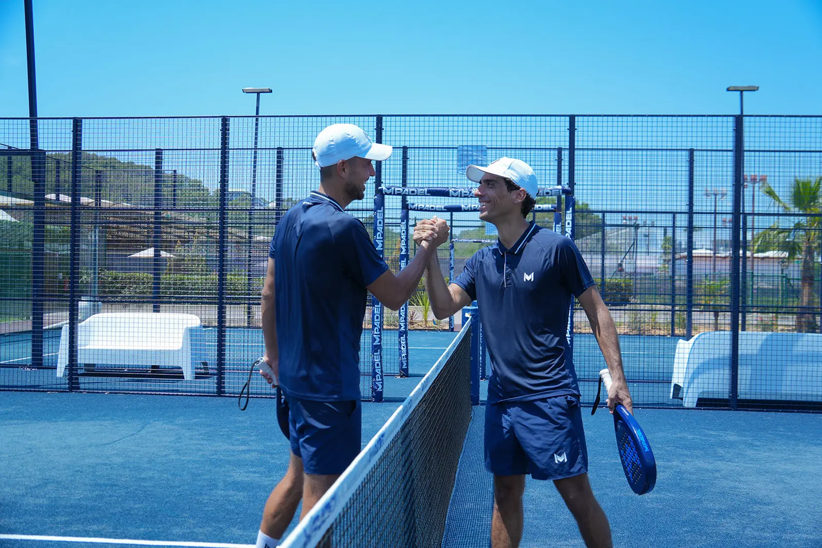 Two padel players shaking hands at the net in Bodrum