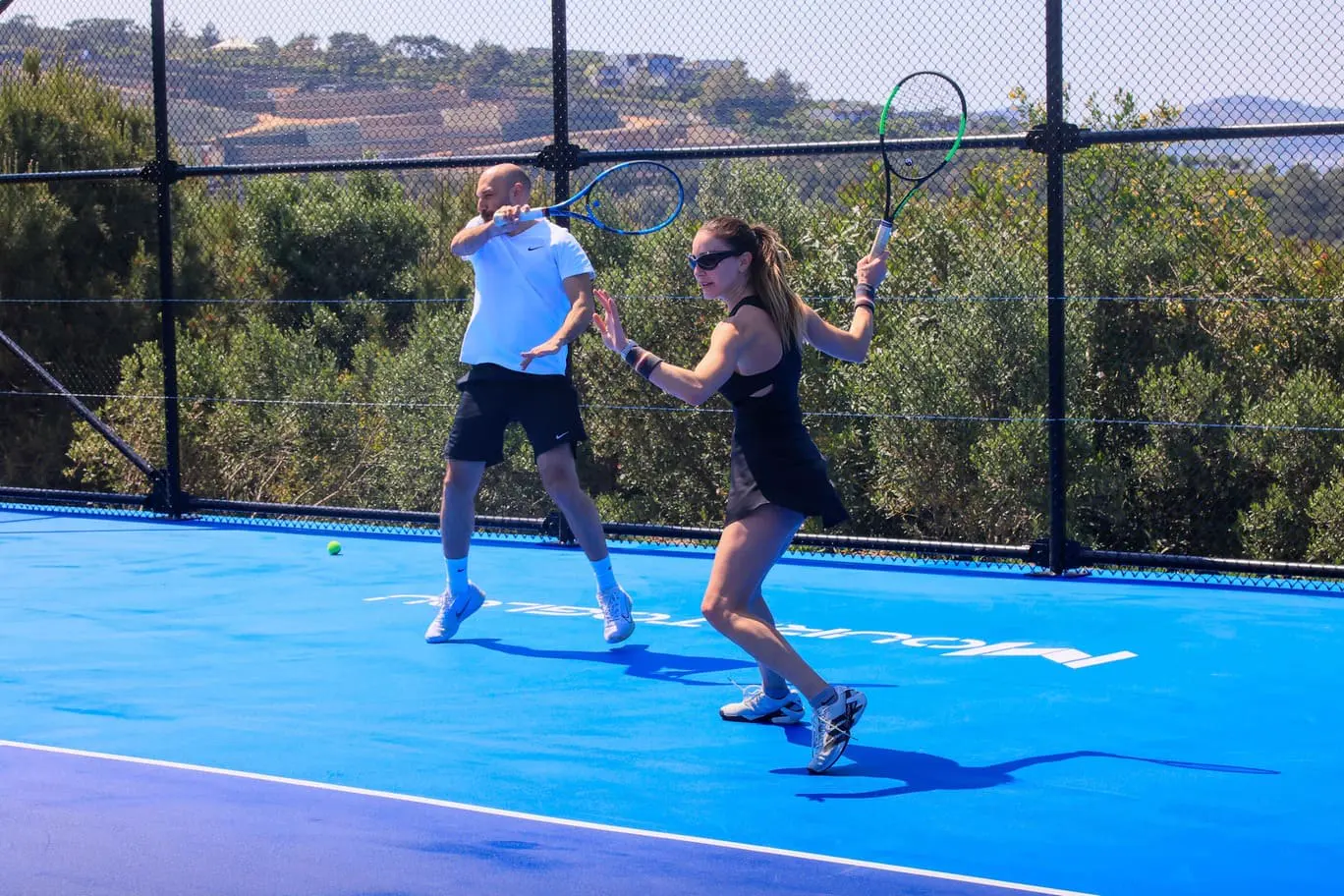 Player hitting a forehand during a semi-private tennis lesson in Bodrum