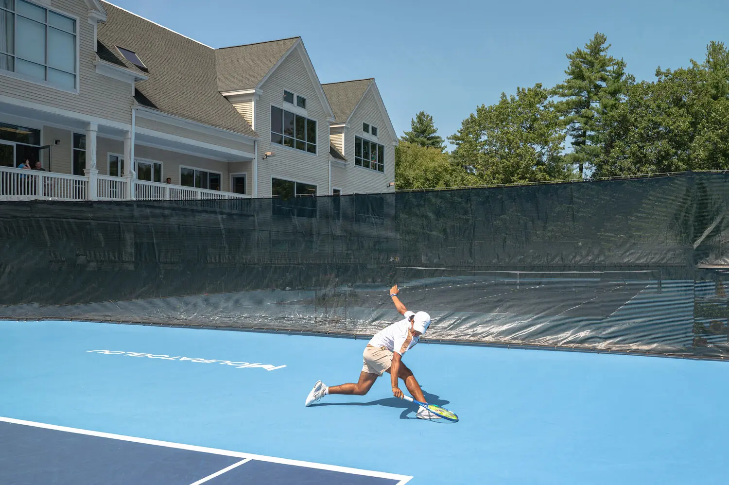 Jugador junior entrenando en una pista exterior del Mouratoglou Tennis Center Boston