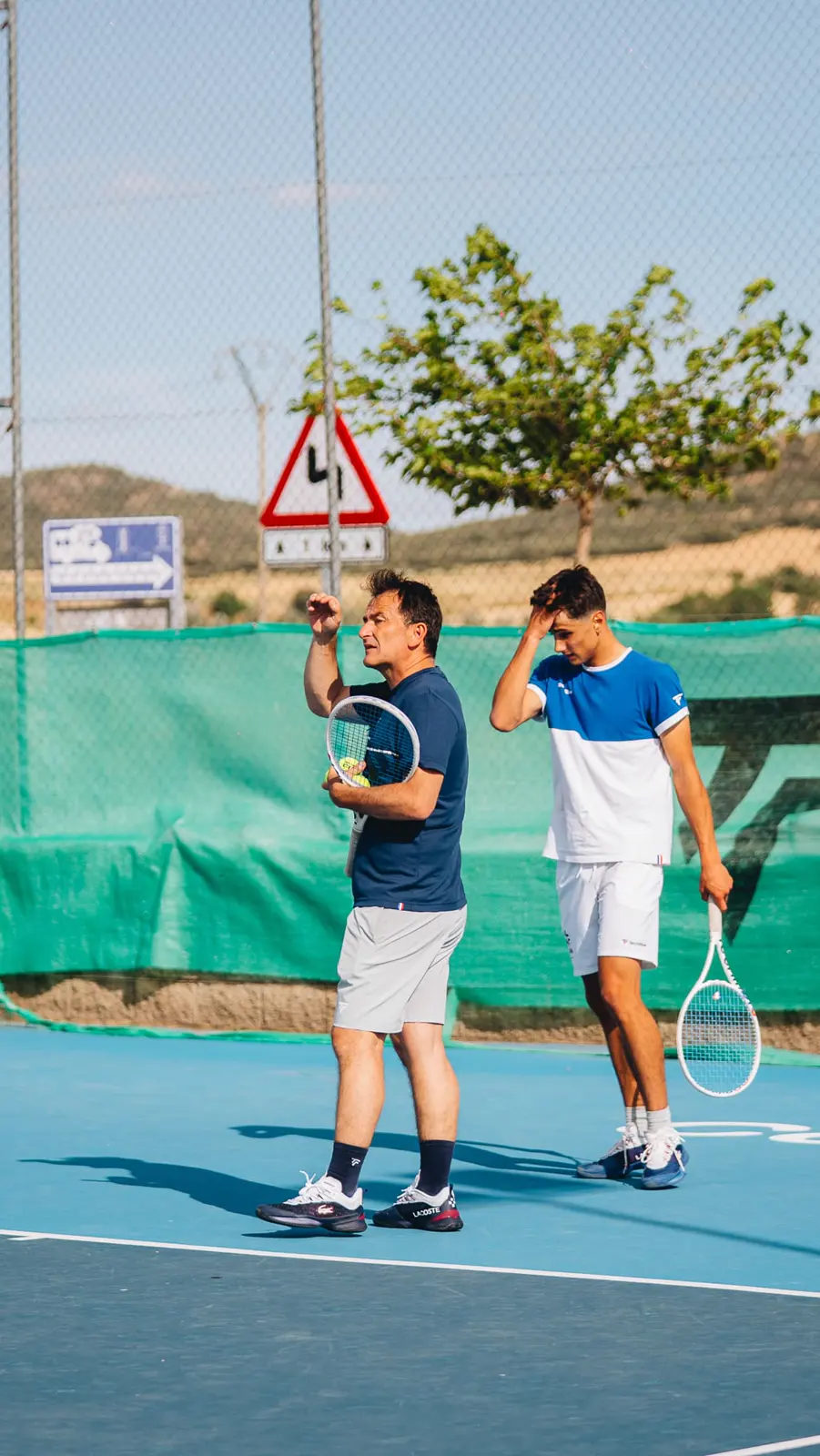Coach running a drill with a young player on court in Calatrava