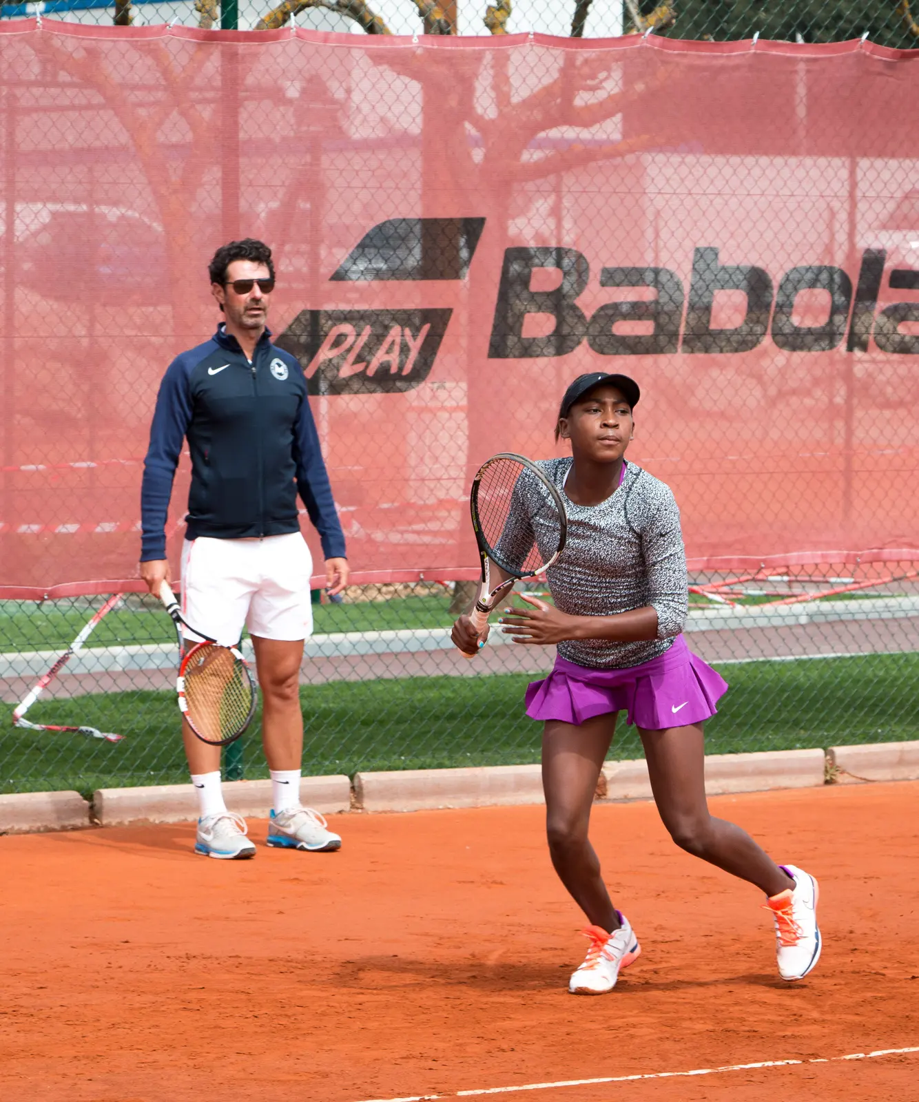 Mouratoglou coach working with a player on a clay court