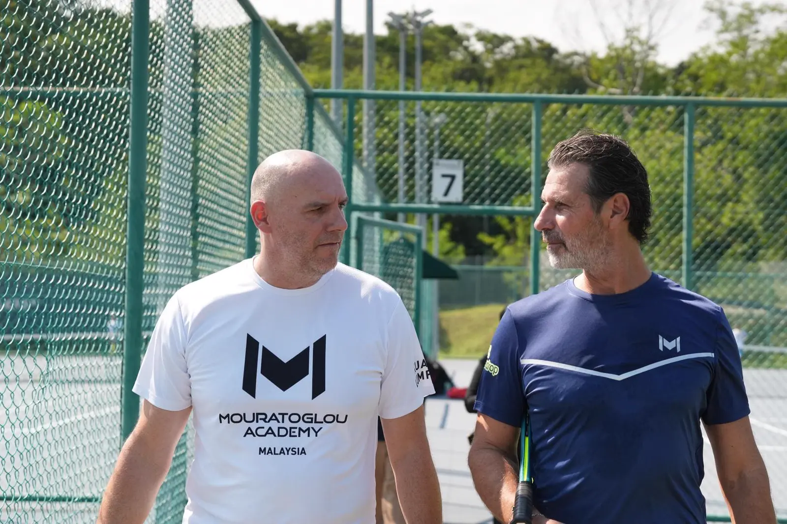 Patrick Mouratoglou paseando con un entrenador en la Mouratoglou Academy Malaysia