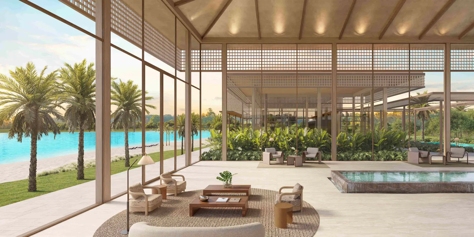 Salón abierto de la casa club con vistas a la laguna y las palmeras en Heritage Riviera.