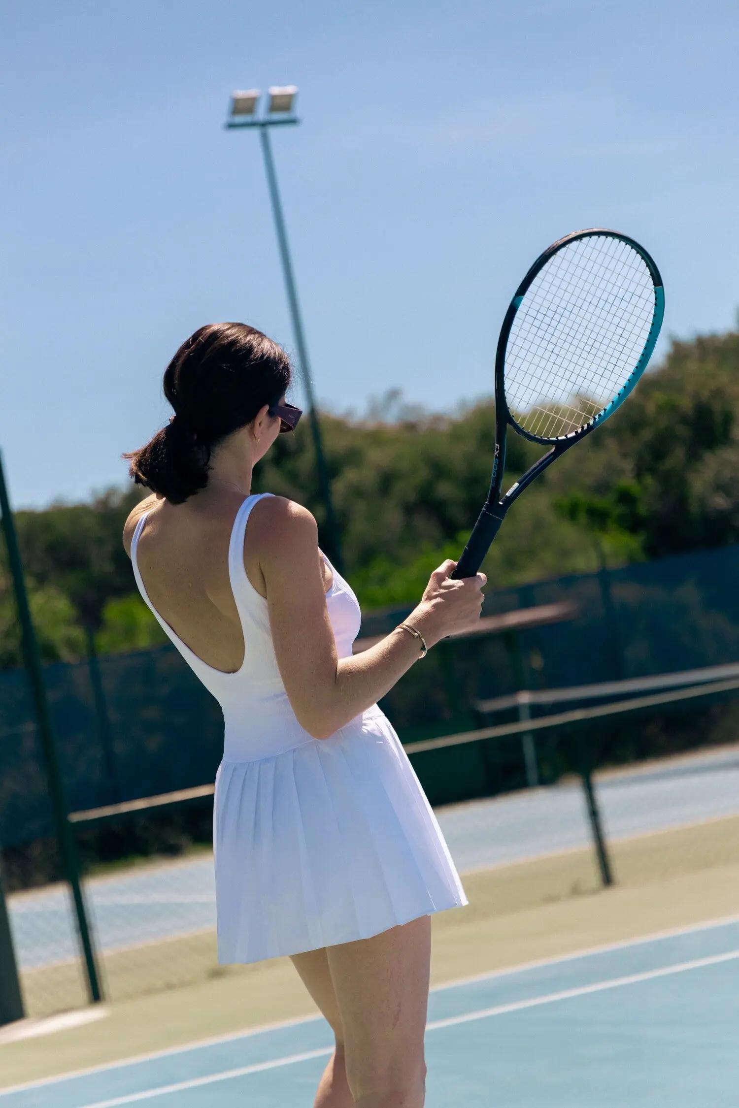 Joueur marchant sur un court de tennis extérieur en dur à Cala di Volpe