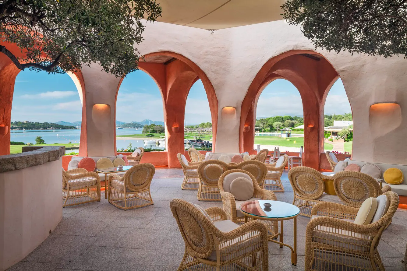 Atrium bar with arches and sea view at Hotel Cala di Volpe