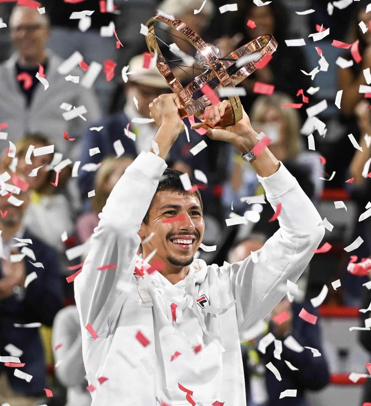 Alexei Popyrin lifting the Montreal Masters 1000 trophy under falling confetti