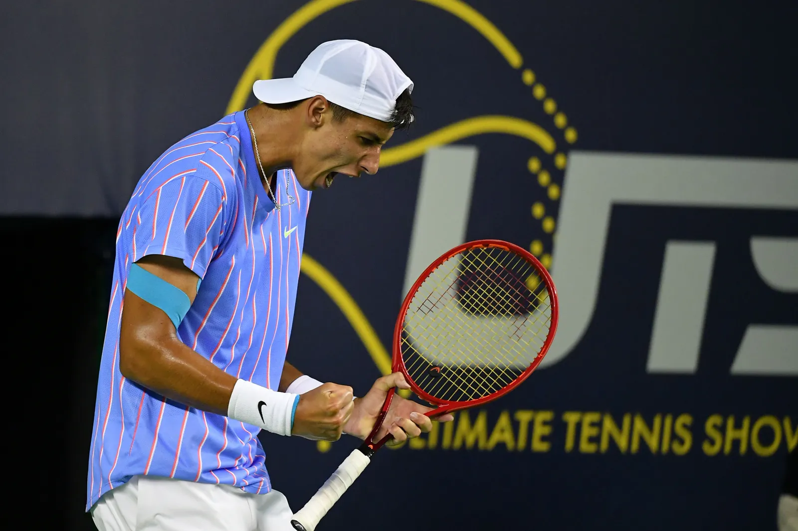 Alexei Popyrin celebrating a point at an Ultimate Tennis Showdown event