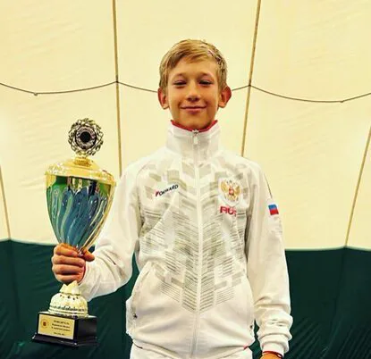 Nikita Berdin holding a trophy