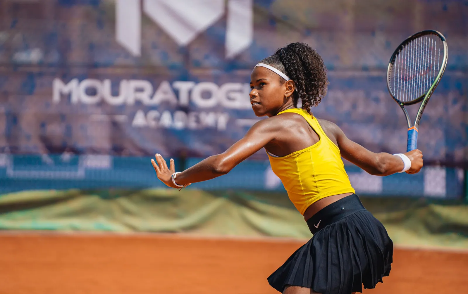 Victoria Barros estirándose para una derecha en tierra batida en la Mouratoglou Academy